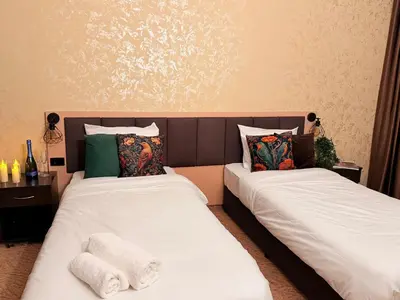two beds sitting next to each other in a room at Hotel NIRÁ in Sofia