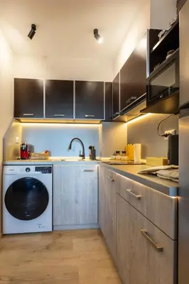 a kitchen with a washing machine in the middle at SkyCloud Bansko Cozy Modern 1 Min to Gondola in Bansko