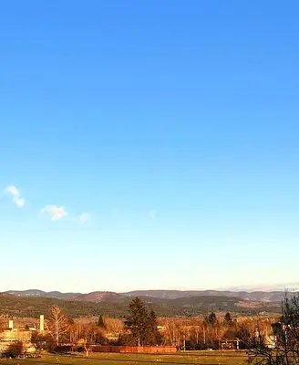 a view of a field with mountains in the distance at Апартамент Релакс in Velingrad