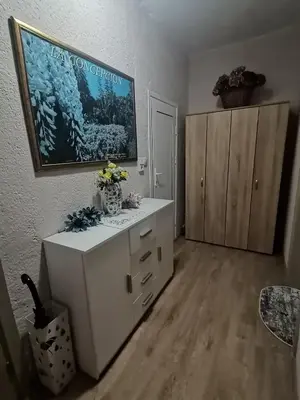 a room with a white cabinet with flowers on it at Апартамент Релакс in Velingrad