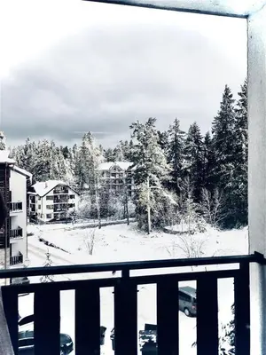 a view of a snow covered yard from a balcony at Borovets luxury studio in Samokov