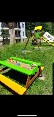 a green and yellow picnic table in the grass at Borovets luxury studio in Samokov
