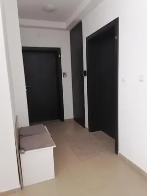 an empty room with two black doors and a bench at Iglika 2, A13 & A14 in Borovets