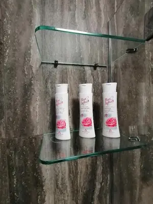 three moisturizers on a glass shelf in a room at Iglika 2, A13 & A14 in Borovets