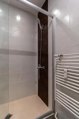 a shower with a glass door in a bathroom at Grand Stamboliyski Residence in Sofia