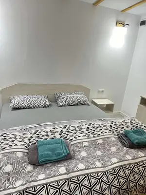 a large bed with two pillows on top of it at Бунгала ЛАГО