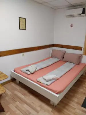 a bed in a room with avertisementatronatronstrationstrationstration at Скай Румс -3 in Sofia