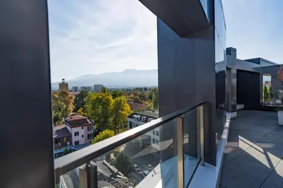 a view from the balcony of a building at Sunny Penthouse with Mountain Views and 180 degrees Terrace in Sofia