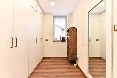 a hallway with white cabinets and a window at Cozy house in the heart of Pirin mountain in Razlog