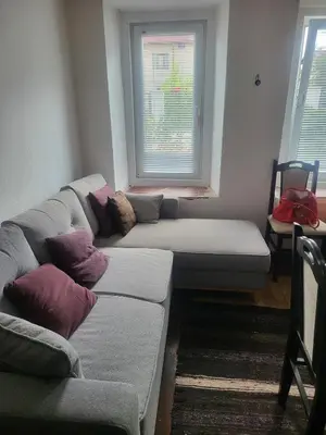 a living room with a couch and a window at Cozy house in the heart of Pirin mountain in Razlog