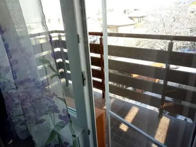 a sliding glass door with a view of a balcony at Бутикови стаи за гости- Felicita in Kyustendil