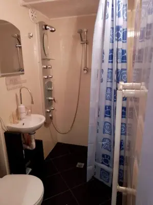 a bathroom with a shower and a toilet and a sink at Бутикови стаи за гости- Felicita in Kyustendil