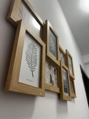 a row of framed pictures on a wall at Vitoshкa Urban Stay in Sofia