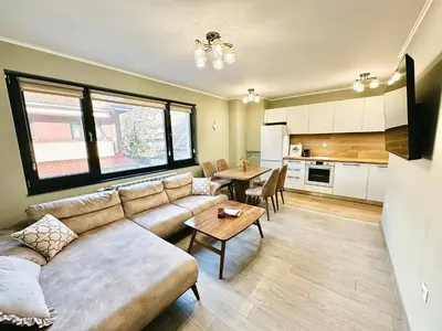 a living room with a couch and a table at Centralside Retreat with Free Parking Spot in Plovdiv