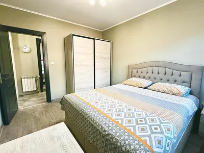 a bedroom with a bed and a large window at Centralside Retreat with Free Parking Spot in Plovdiv