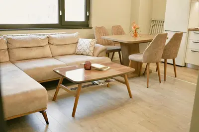 a living room with a couch and a table at Centralside Retreat with Free Parking Spot in Plovdiv