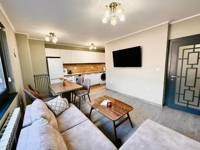 a living room with a couch and a table at Centralside Retreat with Free Parking Spot in Plovdiv