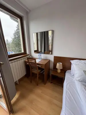 a bedroom with a desk and a bed and a window at Villa Park Borovets in Borovets
