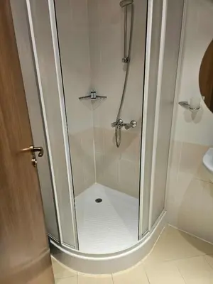 a shower with a glass door in a bathroom at Villa Park Borovets in Borovets