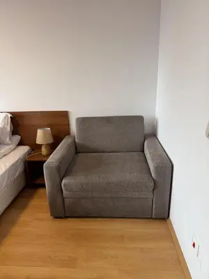 a gray couch in a room with a bed at Villa Park Borovets in Borovets