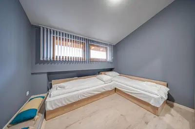 a bedroom with a large bed in the corner at VEGA Apartments - Metro in Sofia