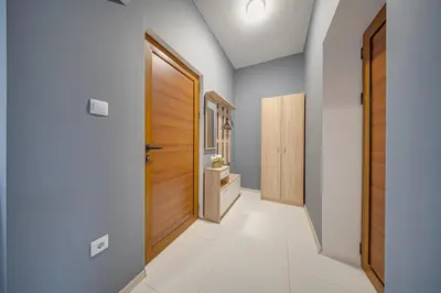 a hallway of a house with a wooden door at VEGA Apartments - Metro in Sofia