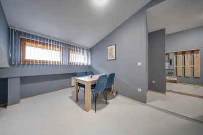 a dining room with blue walls and a table and chairs at VEGA Apartments - Metro in Sofia