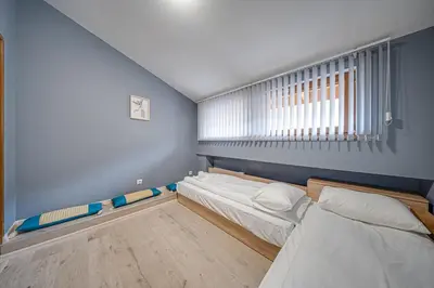 a room with two beds and a window at VEGA Apartments - Metro in Sofia