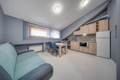 a kitchen with a couch and a table in a room at VEGA Apartments - Metro in Sofia