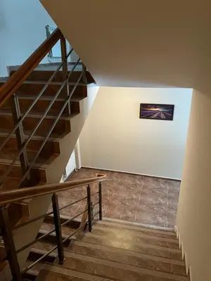 a staircase in a house with a painting on the wall at Hotel Rodope in Pamporovo