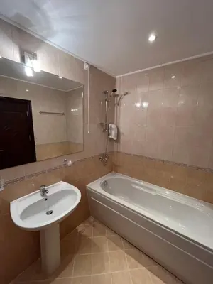 a bathroom with a tub and a sink and a bath tub at Hotel Rodope in Pamporovo