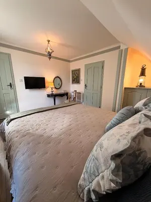 a bedroom with a large bed and a television at Happy House Progled in Progled