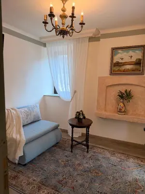 a living room with a blue couch and a chandelier at Happy House Progled in Progled