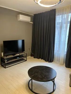 a living room with a coffee table and a flat screen tv at Apartment in city center in Sofia