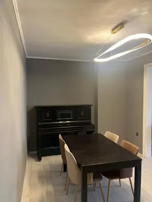 a dining room with a table and a piano at Apartment in city center in Sofia
