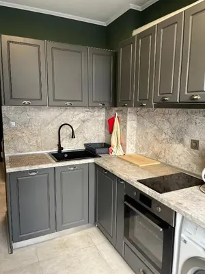 a kitchen with gray cabinets and a sink at Apartment in city center in Sofia