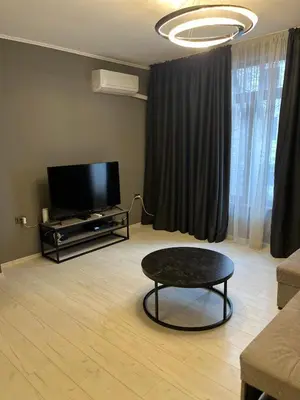 a living room with a tv and a coffee table at Apartment in city center in Sofia