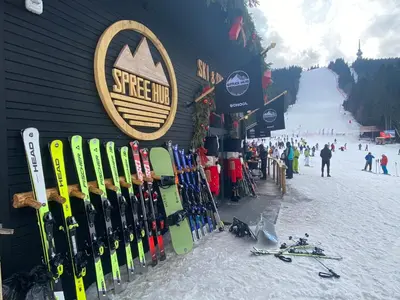 a bunch of skis are lined up against a building at Castle Inn Pamporovo 2 Bedroom Apartment in Pamporovo