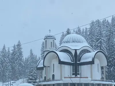 a building covered in snow with a tower at Castle Inn Pamporovo 2 Bedroom Apartment in Pamporovo