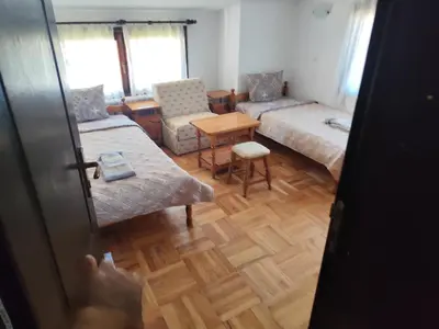 a room with a living room with a couch and a table at Къща за гости Свети Георги in Pamporovo