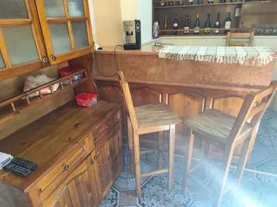 a kitchen with a bar with two chairs and a counter at Къща за гости Свети Георги in Pamporovo