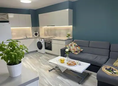 a living room with a couch and a table at Cozy Central Apartment-Welcome Coffee and Wine in Sofia