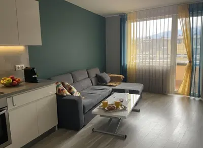 a living room with a couch and a table at Cozy Central Apartment-Welcome Coffee and Wine in Sofia