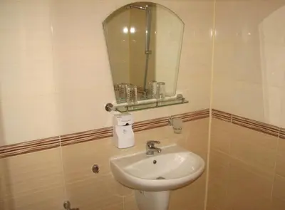 a bathroom with a sink and a mirror at Hotel Boyanovi in Bansko
