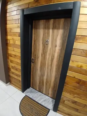 a wooden door in a room with a wooden wall at Estrella Apartment in Velingrad
