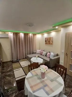 a living room with two tables and a couch at Estrella Apartment in Velingrad