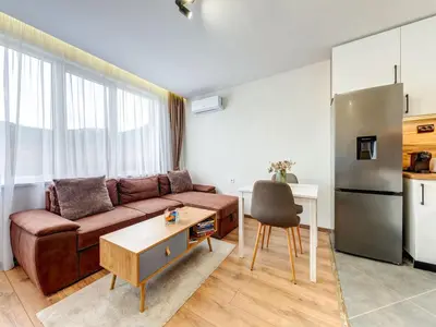 a living room with a couch and a table at Stylish 1BR in the Heart of Town in Smolyan