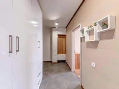 a room with a hallway with white cabinets and a door at Stylish 1BR in the Heart of Town in Smolyan