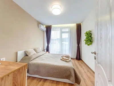 a bedroom with a bed and a window at Stylish 1BR in the Heart of Town in Smolyan