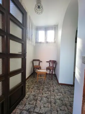 a room with a table and chairs and a door at Къща за гости Йони in Teteven